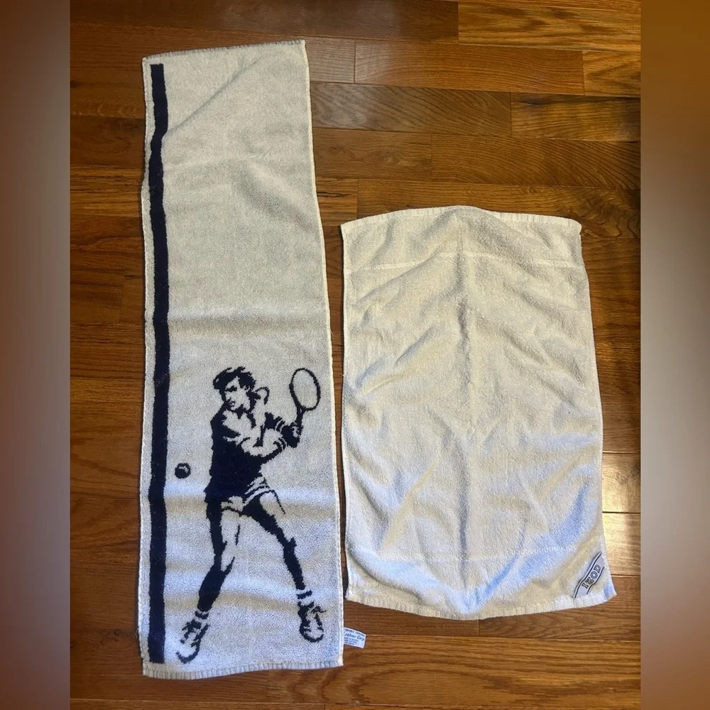 2 sports towels. 1 is reversible and has a tennis player. 1 is izod brand.